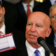 House representative Kevin Brady holds up a sample tax-filing post card in 2017.